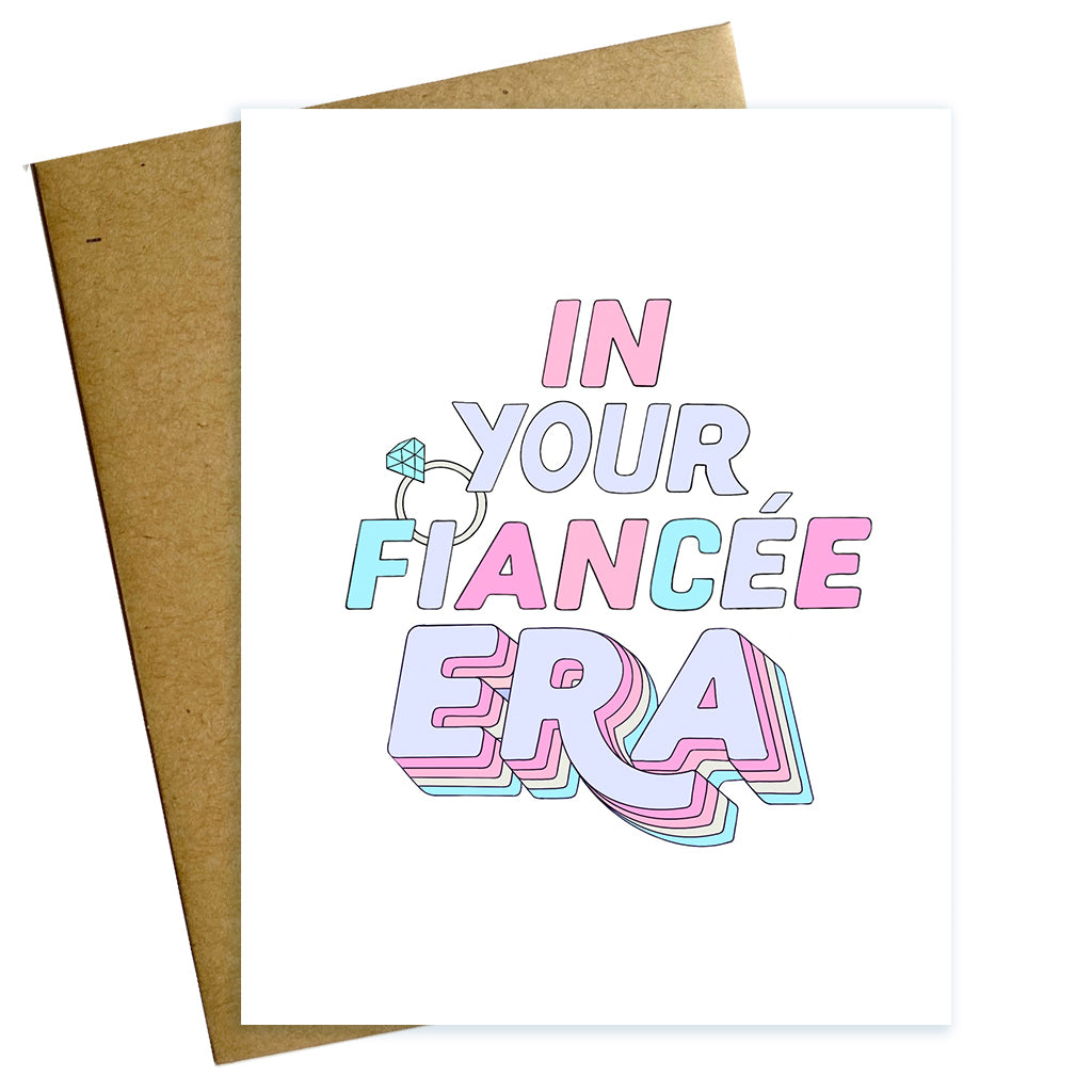 Hand lettered, Taylor Swift inspired engagement card reading In Your Fiancée Era with illustration of a diamond engagement ring